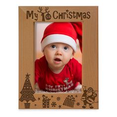 a wooden frame with a baby wearing a santa hat