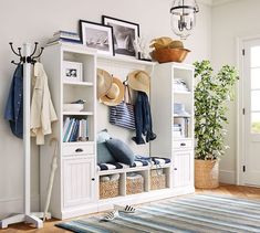 a white bookcase filled with hats and other items