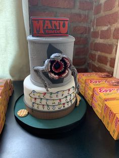 there is a cake made to look like a shoe on top of a stack of boxes