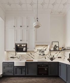 a kitchen with marble counter tops and black cabinets, along with an oven and dishwasher