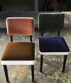 three different colored chairs sitting next to each other