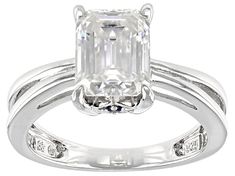 an emerald - cut diamond ring set in 18k white gold