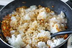 rice and carrots cooking in a pan on the stove