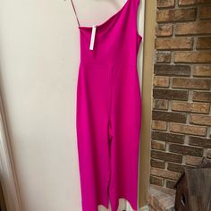 Beautiful Asymmetrical One Shoulder Jumpsuit. No Buttons Or Zippers. Pull On For Easy Access. Wide Leg Pant. Size Medium Color Fuchsia Pink Measures 15x55” One-shoulder Jumpsuits And Rompers For Spring Date Night, One-shoulder Jumpsuits And Rompers For Date Night, Chic Pink One-shoulder Jumpsuit, Summer Asymmetrical Jumpsuits And Rompers, Asymmetrical Jumpsuits And Rompers For Summer, Spring Fitted Jumpsuit With Asymmetrical Neckline, Fitted Jumpsuit With Asymmetrical Neckline For Spring, Asymmetrical Jumpsuits And Rompers For Night Out In Spring, Spring Jumpsuits And Rompers With Asymmetrical Neckline