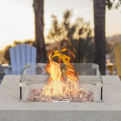 a fire pit sitting on top of a cement table