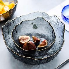 some figs are sitting in a bowl on a table