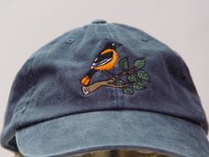 NEW EMBROIDERED BALTIMORE ORIOLE BIRD WILDLIFE BASEBALL HAT (HATS PICTURED ARE NAVY, PURPLE, CHARCOAL, WILD PLUM AND BLACK) Adams Optimum 6 Panel Baseball Hat Low Profile - 100% Cotton Twill Adult Cap Pigment Dyed - Garment Washed Hat 6 Panels with Sewn Matching Eyelet Visor with 3 Rows of Stitching Pre-formed Bill - Leather Strap with Brass Grommet Adjustable - One Size Fits Most An Extremely Comfortable Baseball Hat! Enjoy the Embroidered Baltimore Oriole Bird Wildlife Hat! We have 24 Differen Baltimore Orioles Birds, Embroidery Apparel, Bird Hat, Oriole Bird, Baltimore Oriole, How To Wash Hats, Embroidered Bird, Embroidery On Clothes, Quality Hats