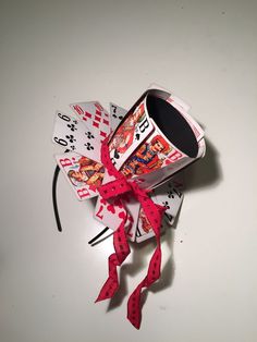 a coffee cup and playing cards tied to a string