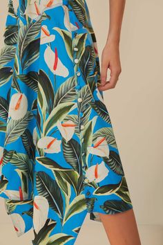 Step into a tropical oasis with the Blue Anthurium Garden Asymmetric Midi Skirt by FARM Rio. A vision in azure, this piece blooms with lush anthuriums and verdant foliage, creating a vibrant print that captivates and charms. The midi skirt flutters with an asymmetric hemline, adding a playful twist to your every move, while the high-waisted silhouette gracefully flatters the form. Embody the spirit of summer days and let this unique skirt speak to your penchant for daring elegance and joyful fashion narratives. Composition 100% COTTONCare Instructions MACHINE WASH GENTLE CYCLE, DO NOT BLEACH, DO NOT TUMBLE DRY, LINE DRYING, IRON AT LOW HEAT, DRY CLEAN WITH ANY SOLVENT EXCEPT TRICHLOROETHYLENESize and Fit Inches XXS XS S M L XL Bust N/A N/A N/A N/A N/A N/A Waist 24 3/4 26 3/4 28 3/4 30 3/4 Blue Tropical Print Bottoms For Spring, Blue Anthurium, Anthurium Garden, Unique Skirt, Unique Skirts, Line Drying, Tropical Oasis, Farm Rio, Summer Days