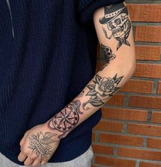 a man with tattoos on his arm and hand