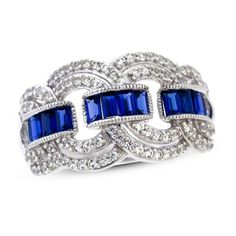 Artful and sophisticated, this gorgeous ring for her is full of eye-catching color and sparkle. Brilliant baguette-cut blue lab-created sapphires form a trio of links that gracefully entwine with crossing ribbons of radiant white lab-created sapphires. The ring is fashioned in stylish sterling silver. Elegant Sapphire Rings For Evening, Elegant Evening Sapphire Rings, Art Deco Blue Cubic Zirconia Rings, Blue Cubic Zirconia Art Deco Rings, Elegant Blue Sapphire Ring, Blue Sapphire Ring With Baguette Diamonds, Blue Diamond Ring For Evening, Elegant Sapphire Ring With Baguette Diamonds, Elegant Baguette Cut Sapphire Jewelry