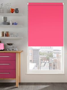 a pink roller shade in a kitchen window