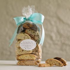 a bag full of cookies sitting on top of a table next to some pieces of bread