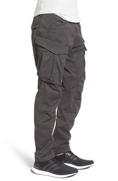 Stretch-cotton pants in a tapered profile rock a modern, utilitarian look with cargo-style pockets and ergonomic seaming for a more active fit. 32" inseam; 14" leg opening; 10" front rise; 15" back rise (size 32) Zip fly with button closure Side slant pockets; back flap pockets; side cargo pockets 97% cotton, 3% elastane Machine wash, dry flat Imported Functional Cotton Pants With Side Pockets, Cotton Cargo Jeans For Outdoor Activities, Cotton Pants With Functional Pockets, Combat Cargo Pants With Relaxed Fit And Side Pockets, Combat Style Cotton Parachute Pants With Straight Leg, Cotton Combat Parachute Pants With Straight Leg, Combat Style Cotton Parachute Pants, Functional Cotton Cargo Pants, Utility Cotton Cargo Pants For Outdoor Activities