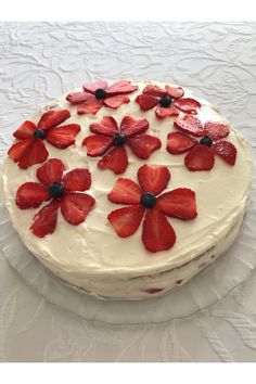 a cake with white frosting and strawberries on top