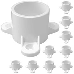 there are many cups and saucers on the white table with one cup in the middle