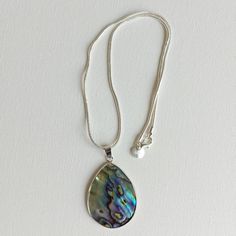 Abalone / paua shell necklace on stainless steel snake chain (to prevent tarnishing).    Presented in velvet -lined gift box. Length: approximately 42cms Pendant length: 42mms Pendant width: 32mms Check out my full jewellery range at: www.tanyajaynechains@etsy.com Silver Shell Necklace With Pearl Pendant As Gift, Silver Mother Of Pearl Shell Necklace As Gift, Silver Shell Pendant Necklace For Gift, Silver Shell Necklace With Round Pendant For Gift, Silver Pendant Shell Necklace Gift, Adjustable Silver Shell Necklace In Mother Of Pearl, Adjustable Silver Mother Of Pearl Shell Necklace, Shell Necklace With Large Pendant, Gift Shell Necklace With Large Pendant