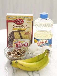 ingredients to make a cake sitting on a counter top next to a bottle of milk