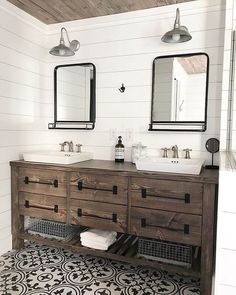 a bathroom with two sinks and mirrors on the wall above it is decorated in black and white tile