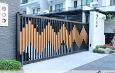 the gate is decorated with an orange and black design on it's side wall