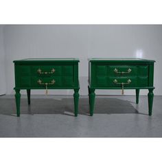 pair of green nightstands with brass handles