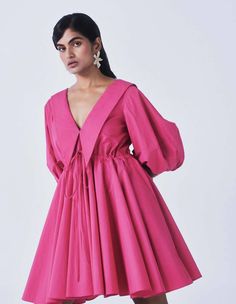 This dress emphasizes volume through its balloon sleeves, drawstring waist, and oversized collar. This dress is an unmistakable favorite. It has inseam pockets. Fabric: Poplin Fabric Composition: 100% cotton Color: Hot Pink Care: Dry clean only. Handmade In India Loose fit with the drawstrings Akanksha is wearing size S with a Tall fit. She is 5'7 in height. The length of the dress is31"( Petite)33" (Standard)35" (Tall) Neck depth from shoulder: 11" PLEASE NOTE : Delivery takes maximum 15 to 17 Oversized Collar Dress, Hot Pink Dress, Oversized Collar, Hot Pink Dresses, Independent Women, Balloon Sleeves, Poplin Fabric, Festival Wear, Natural Fabrics