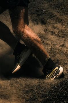 the legs and feet of a person walking on dirt