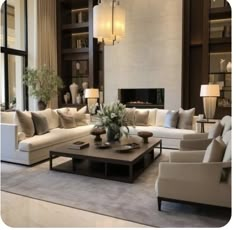 a living room filled with lots of white furniture and large windows in the back ground