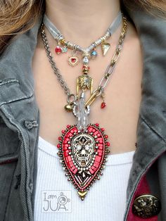 Fun and whimsy layering necklaces. Both of these layering necklaces are each sold separately: choose style from drop-down menu at checkout. Descriptions for each below: 1. Red Heart Skull embroidery necklace with brass skull filigree beaded with various glass beads and crystal chains all around, mixed link necklace and lobster clasp complete the design.  Necklace is 17 inches long with 2 inches extension chain. The pendant is removable and measures 3 inches long.  2. Silver Velvet Ribbon necklace with multiple charms. The center skeleton arms and head are moving and is measuring 3 inches long. Five smaller charms are cz flower, two gold plated hearts, Czech glass bead, abd red skull head with rhinestones for the eyes. The velvet ribbon measures 48 inches long and can be worn as choker or l Bohemian Multi-strand Layered Necklace With Double Chain, Red Glass Bohemian Necklace, Bohemian Multi-strand Layering Necklace, Skull Filigree, Skeleton Arm, Heart Skull, Red Multi-strand Bohemian Necklace, Skull Embroidery, Embroidery Necklace