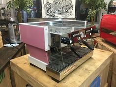 an espresso machine sitting on top of a wooden table