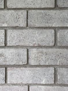 a brick wall that is made out of grey bricks and has no mortars on it