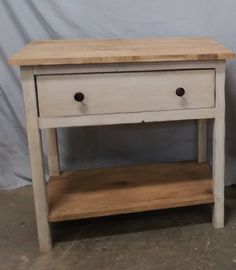 a white wooden table with two drawers