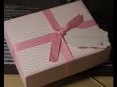 a pink gift box with a tag on it