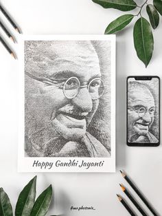 an image of gandhi on a card next to some pencils and green leaves with the caption happy gandhi jaganti