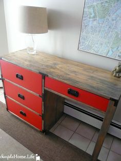 a desk with drawers and a lamp on top