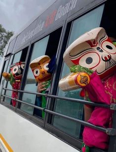 people wearing masks on the side of a bus