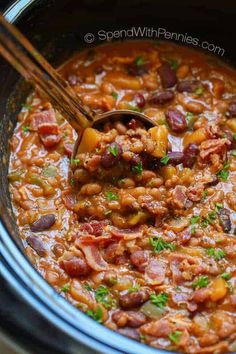 a slow cooker filled with beans and ham