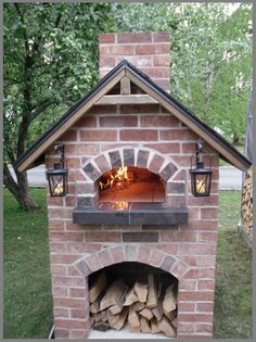 an outdoor brick oven with firewood in it