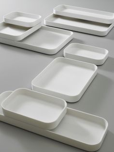 six white plates with different shapes and sizes