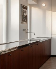 an empty kitchen with wooden cabinets and stainless steel counter tops