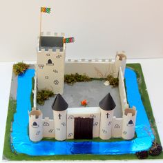 a castle cake with frosting and decorations on it