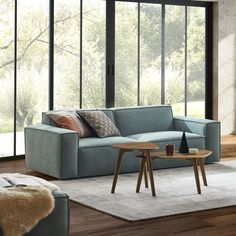 a living room scene with focus on the couch and coffee table in the foreground