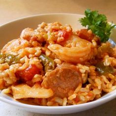 a white bowl filled with rice and meat