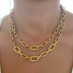 This Italian handcrafted chain link necklace is completely composed of 14K solid gold and is uniquely made with a semi-hollow interior for comfortable everyday wear that will not dent. The chain is centered with three slightly larger links which are finished with a unique rope detailed finish. * ﻿Model is wearing the 18" option. NOTE: This item is available in longer or shorter length options. Kindly message or email us for pricing and details. Total Length: available in your choice of 14, 16, 1 Luxury Handmade Gold-plated Chain Necklace, Luxury Oval Paperclip Chain Jewelry, Yellow Gold Paperclip Chain Necklace With Oval Pendant, Oval Chunky Chain Jewelry Gift, Oval Chunky Chain Jewelry For Gift, Gold Oval Pendant Chain Necklace With Paperclip Chain, Sweetheart Bridal, Gold Link Necklace, Chain Link Necklace