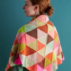 a woman wearing a multicolored knitted shawl