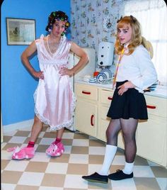 two young women standing next to each other in a room with checkered flooring