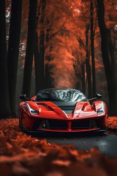 a red sports car parked on the side of a road in front of some trees