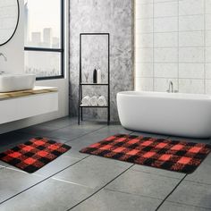 a bathroom with black and white checkered rugs on the floor next to a bathtub