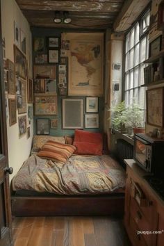 a bed sitting in the middle of a room with lots of pictures on the wall