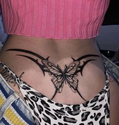 a woman's stomach with a butterfly tattoo on her lower back and upper part